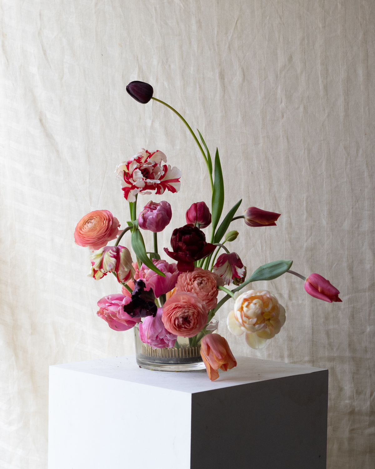 A playful combination of parrot, double and and single tulips, with a few peachy ranunculus.   By Mora, a sustainable, season-led event florist based in Hackney, East London.