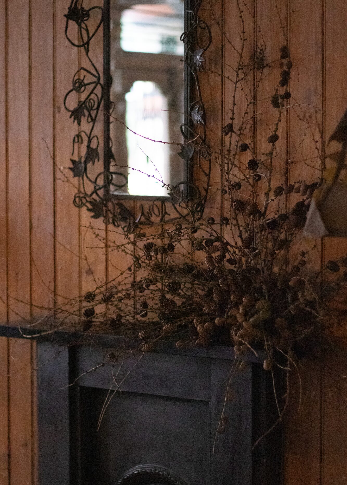 A tangle of larch twigs and cones, for a tonal woodland feel. By Mora, a sustainable, season-led event florist based in Hackney, East London